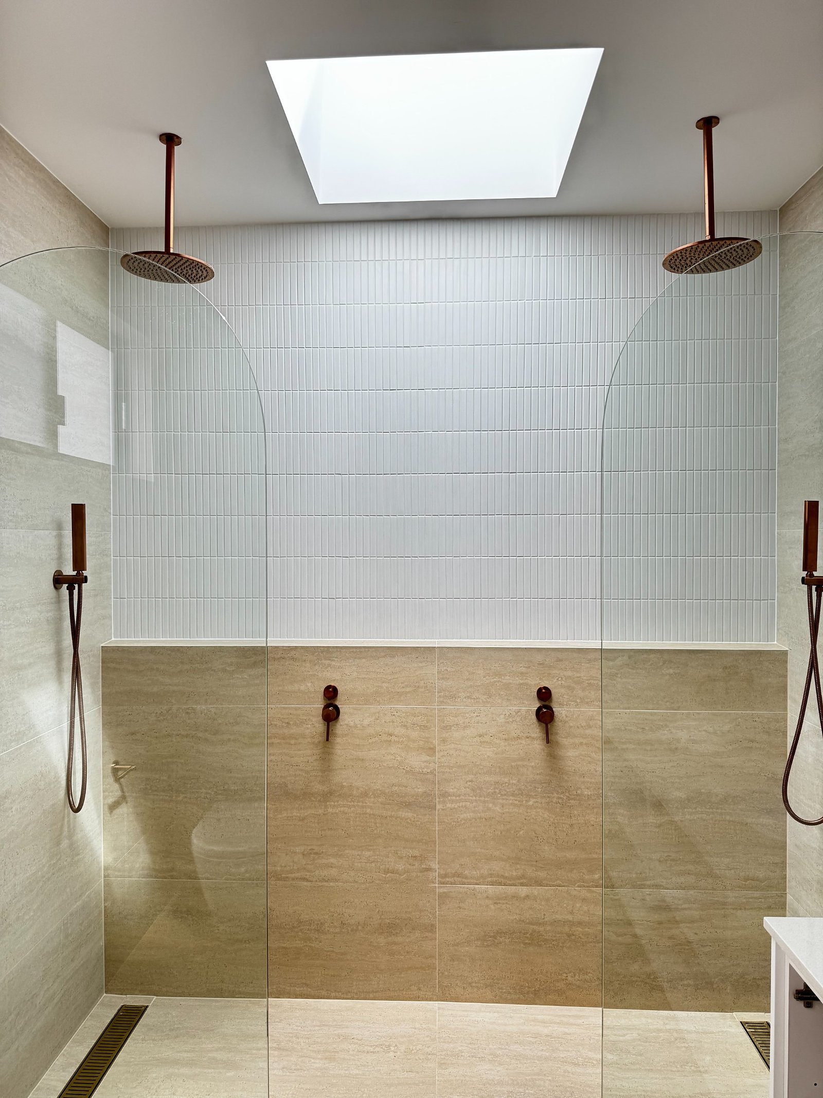 Guildford Duplex double shower with skylight and bronze fixtures
